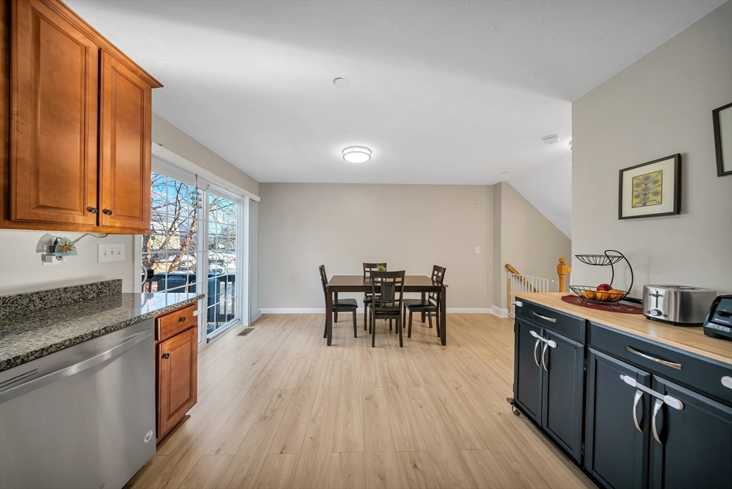 41 Boston Road, Unit 121 Billerica, MA 01862 - Photo 3 of 13 a kitchen with stainless steel appliances granite countertop wooden floors and table