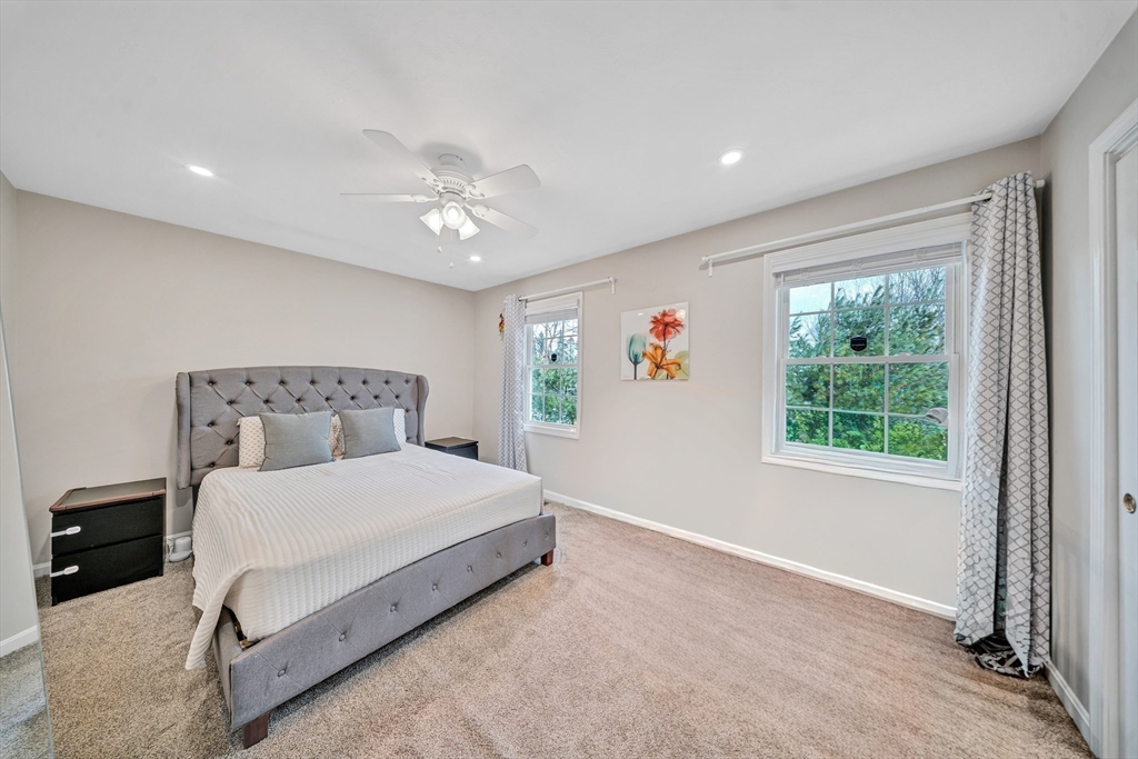 41 Boston Road, Unit 121 Billerica, MA 01862 - Photo 8 of 13 a bedroom with a large bed and a chandelier