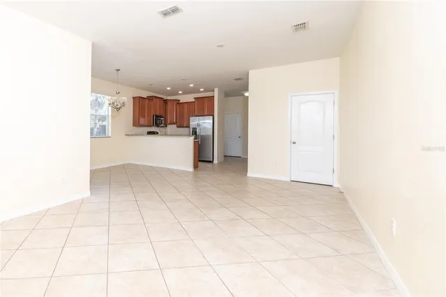 a view of kitchen and hall with a sink