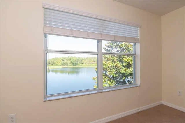 an empty room with closet and a ceiling fan