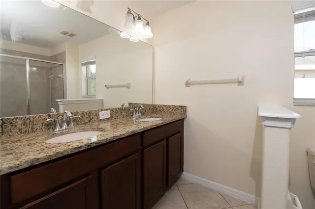 a bathroom with a shower a toilet and a window