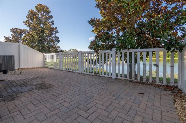 a view of a porch with wooden floor and floor to ceiling window