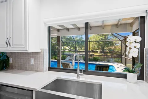 a kitchen with a sink and a large window