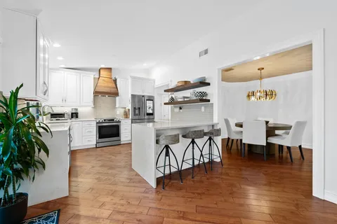 a living room with furniture and kitchen view