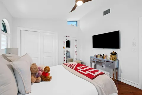 a bedroom with a bed and a flat screen tv