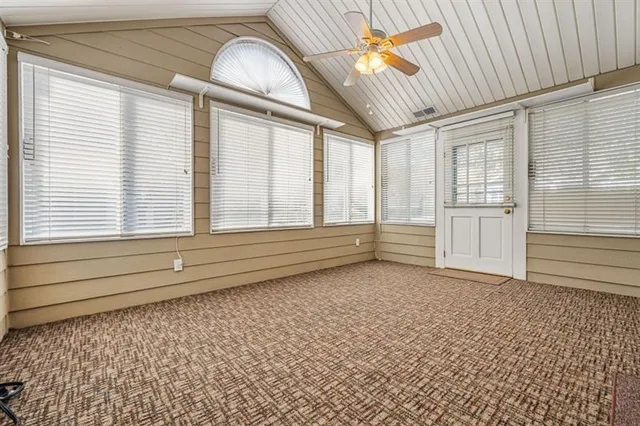 a view of a livingroom with wooden floor and a ceiling fan