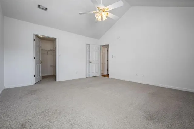 a view of a chandelier fan and fire place