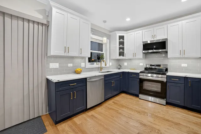 a kitchen with stainless steel appliances granite countertop a stove sink and cabinets