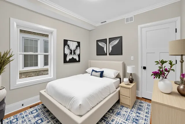 a bedroom with a bed and a window