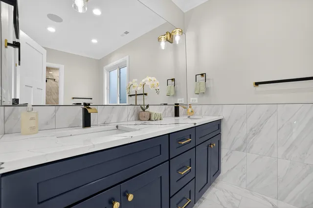 a bathroom with a double vanity sink and a mirror