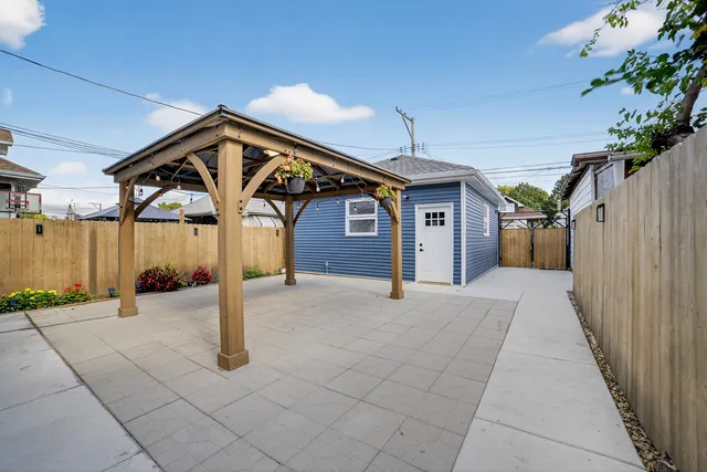 a backyard of a house with table and chairs