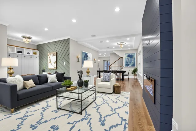 a living room with fireplace furniture and a rug