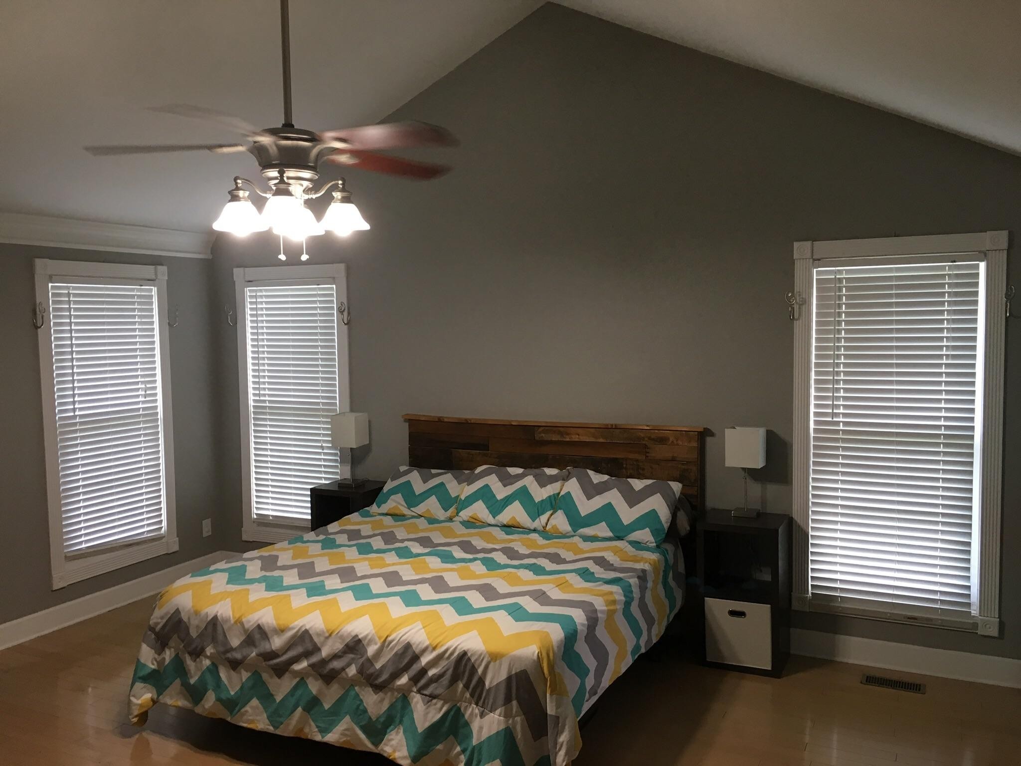 3798 Dutch Valley Road Clinton, TN 37716 - Photo 15 of 37 a bedroom with a bed and a chandelier