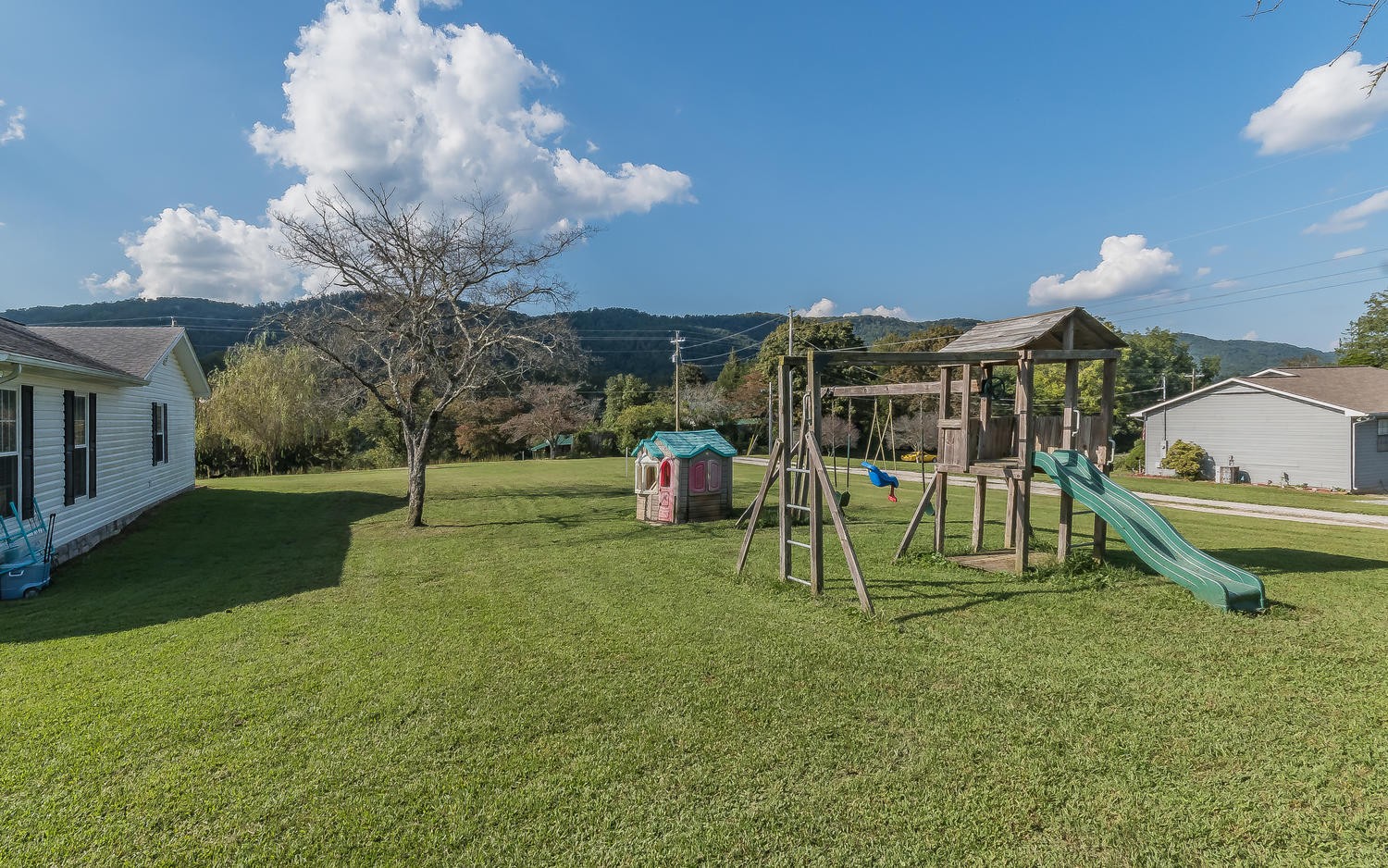 3798 Dutch Valley Road Clinton, TN 37716 - Photo 32 of 37 a view of a house with a backyard and a patio