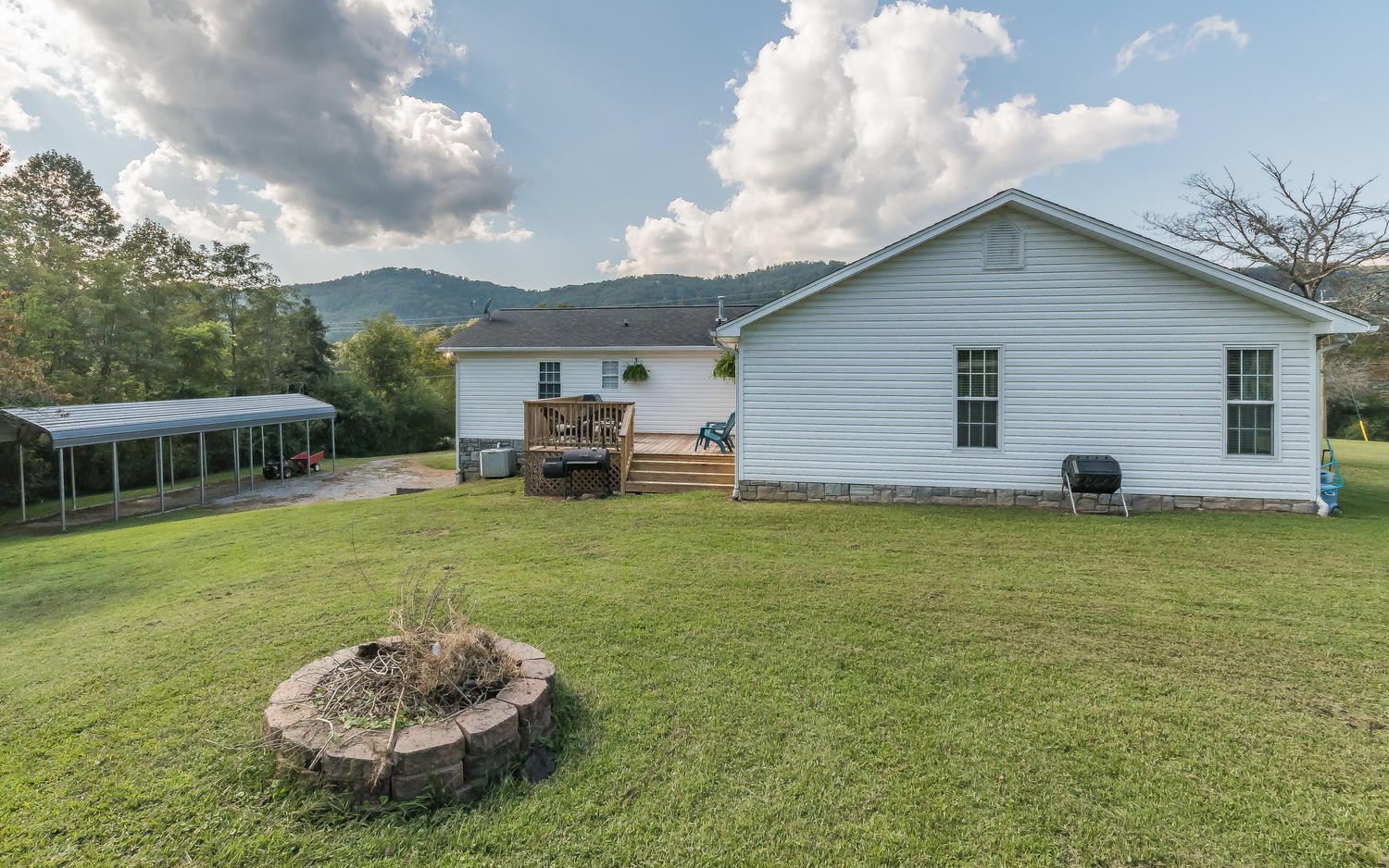 3798 Dutch Valley Road Clinton, TN 37716 - Photo 35 of 37 a backyard of a house with table and chairs