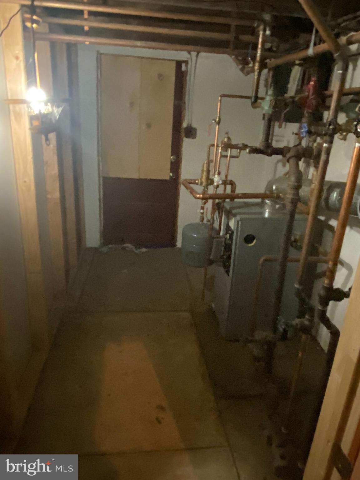 721 Surrey Road Aldan, PA 19018 - Photo 17 of 26 Basement heater and exterior exit from basement