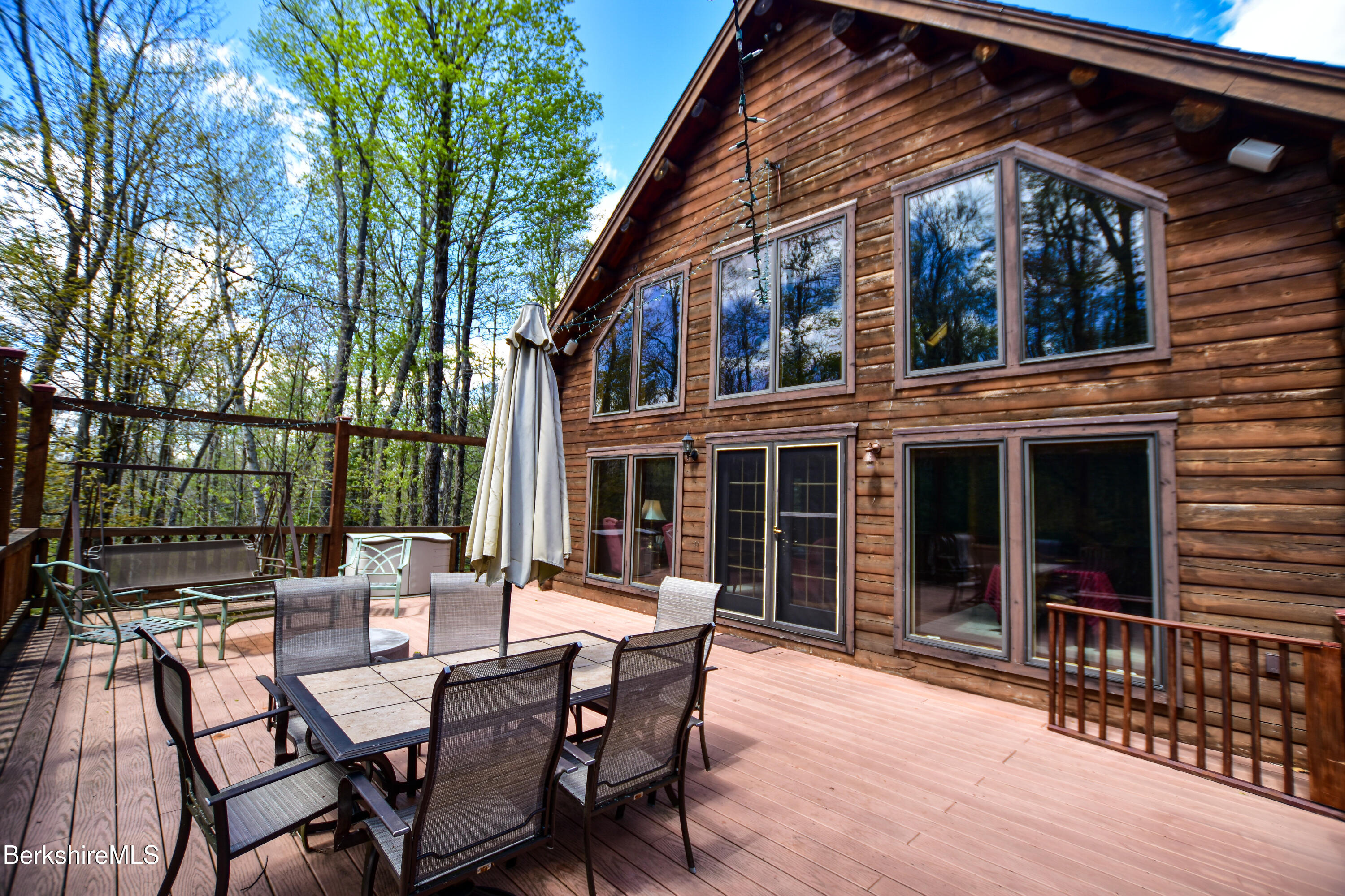 233 Algerie Road Becket, MA 01223 - Photo 44 of 48 a view of a patio with table and chairs and wooden floor