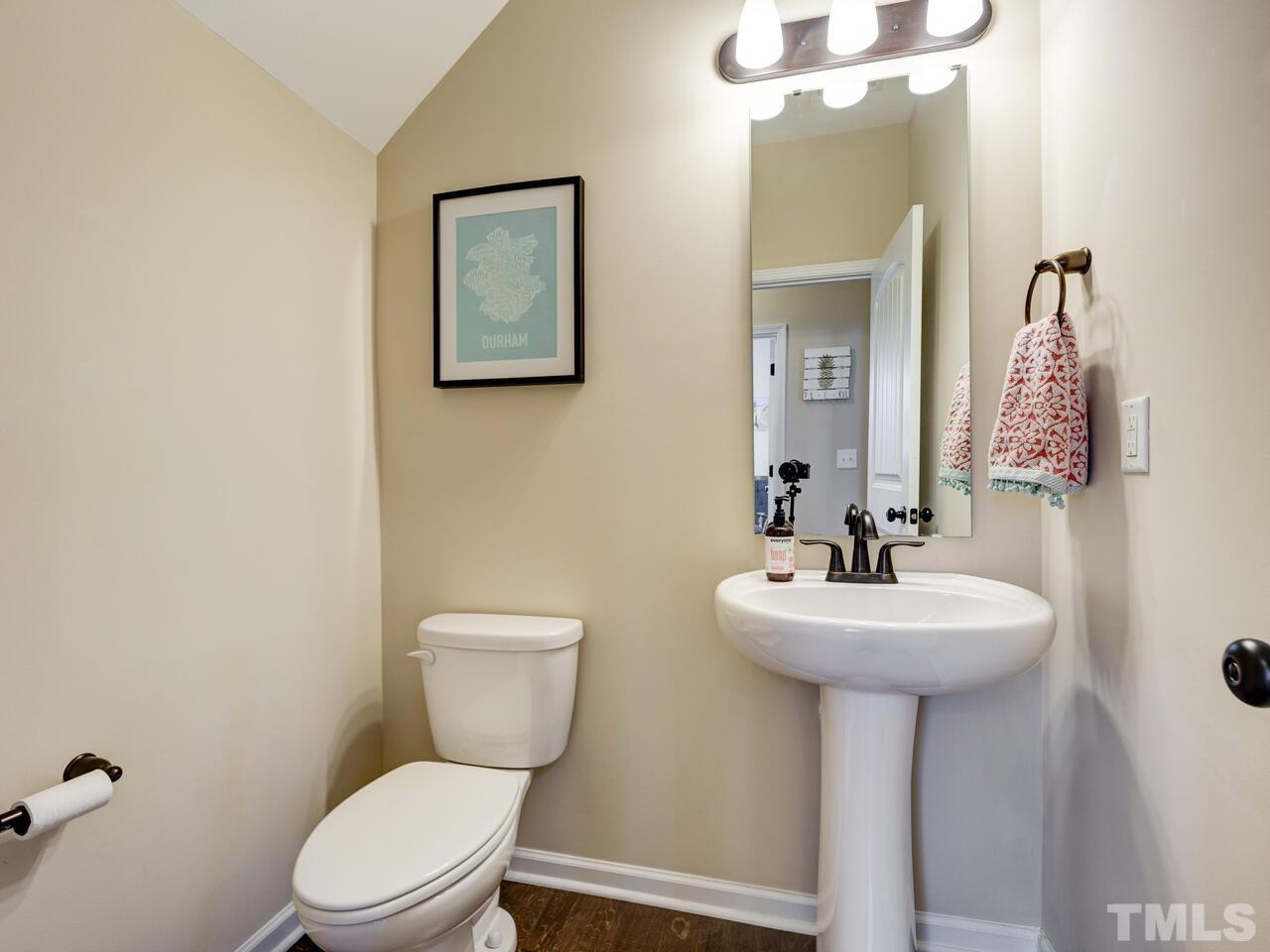 207 Maple Walk Street Durham, NC 27703 - Photo 13 of 50 a bathroom with a toilet sink and mirror