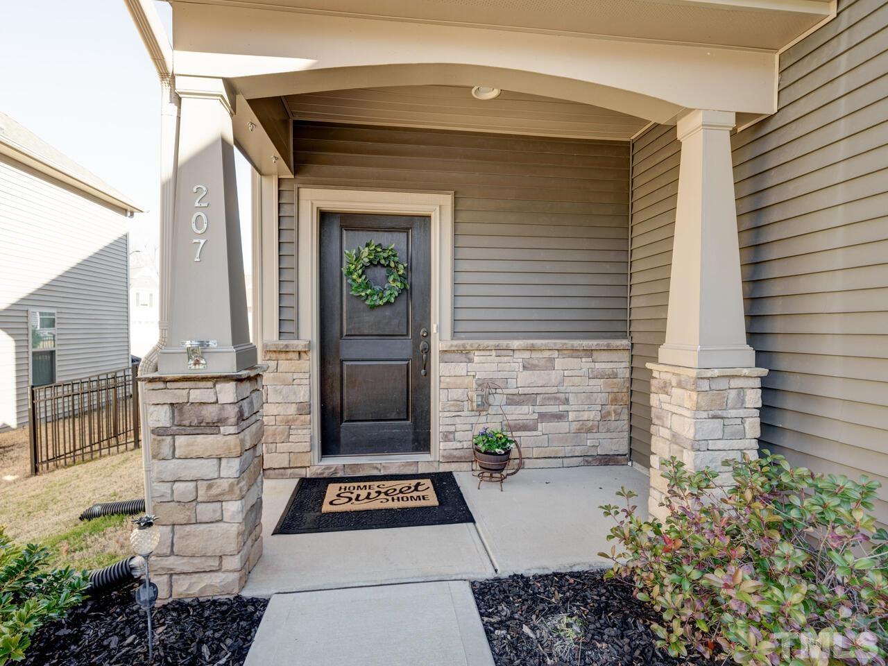 207 Maple Walk Street Durham, NC 27703 - Photo 2 of 50 a front view of a house with a garden