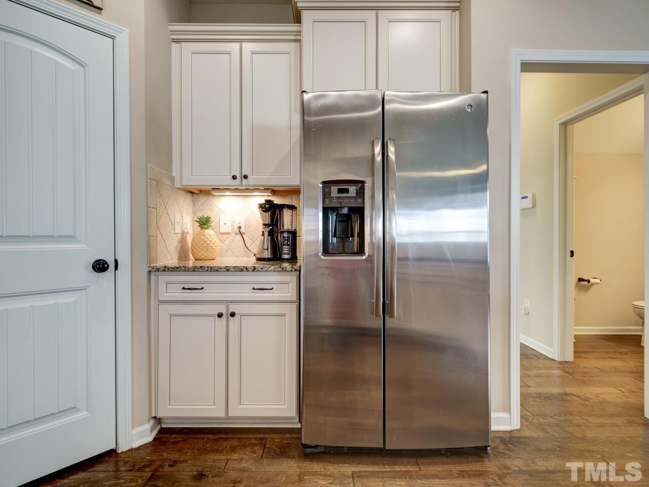 207 Maple Walk Street Durham, NC 27703 - Photo 24 of 50 a kitchen with stainless steel appliances granite countertop a refrigerator and a stove top oven