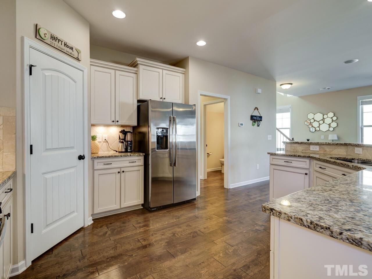 207 Maple Walk Street Durham, NC 27703 - Photo 25 of 50 a kitchen with stainless steel appliances granite countertop a refrigerator a stove and a sink