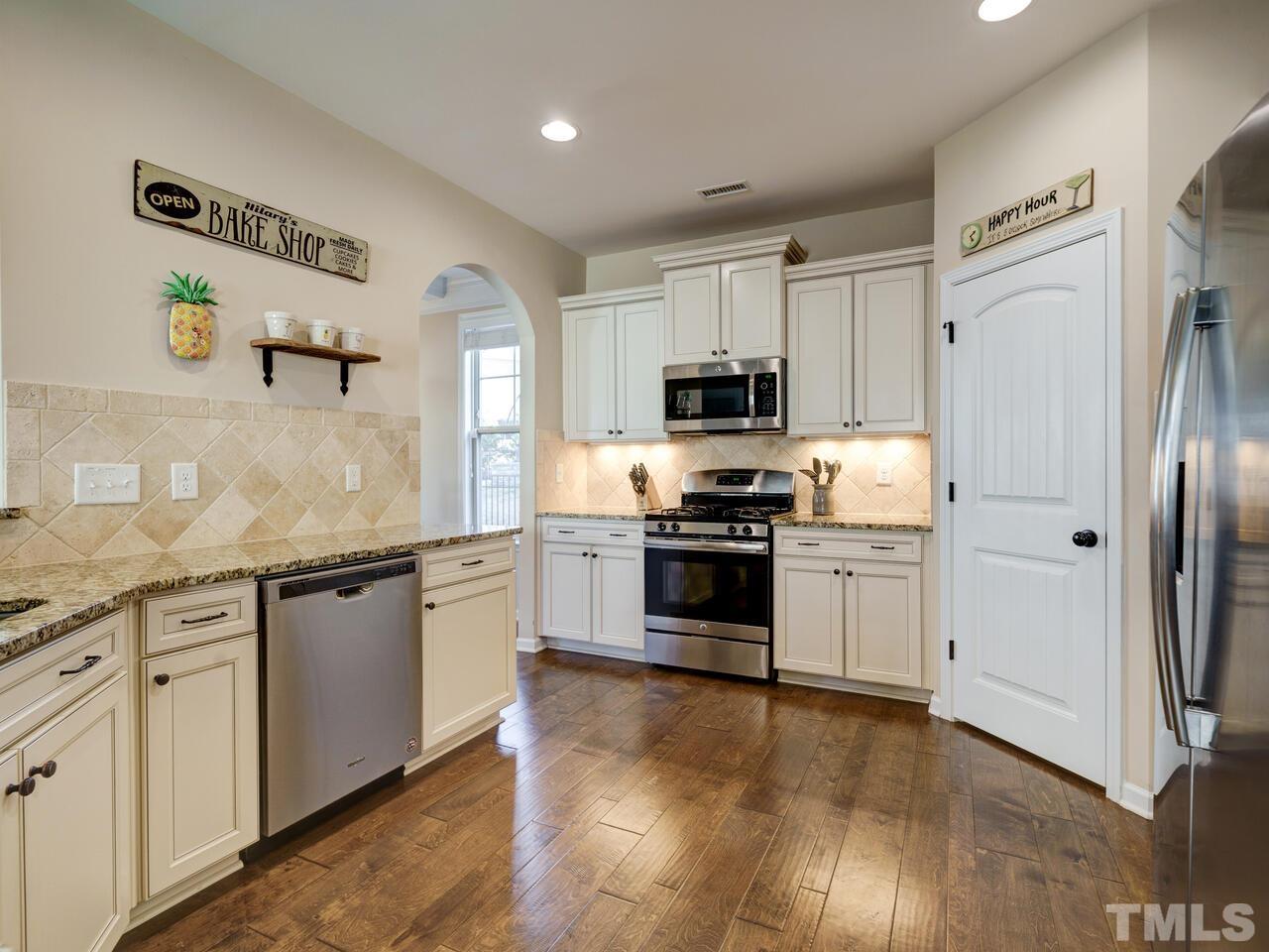 207 Maple Walk Street Durham, NC 27703 - Photo 26 of 50 a kitchen with granite countertop a refrigerator stove and sink