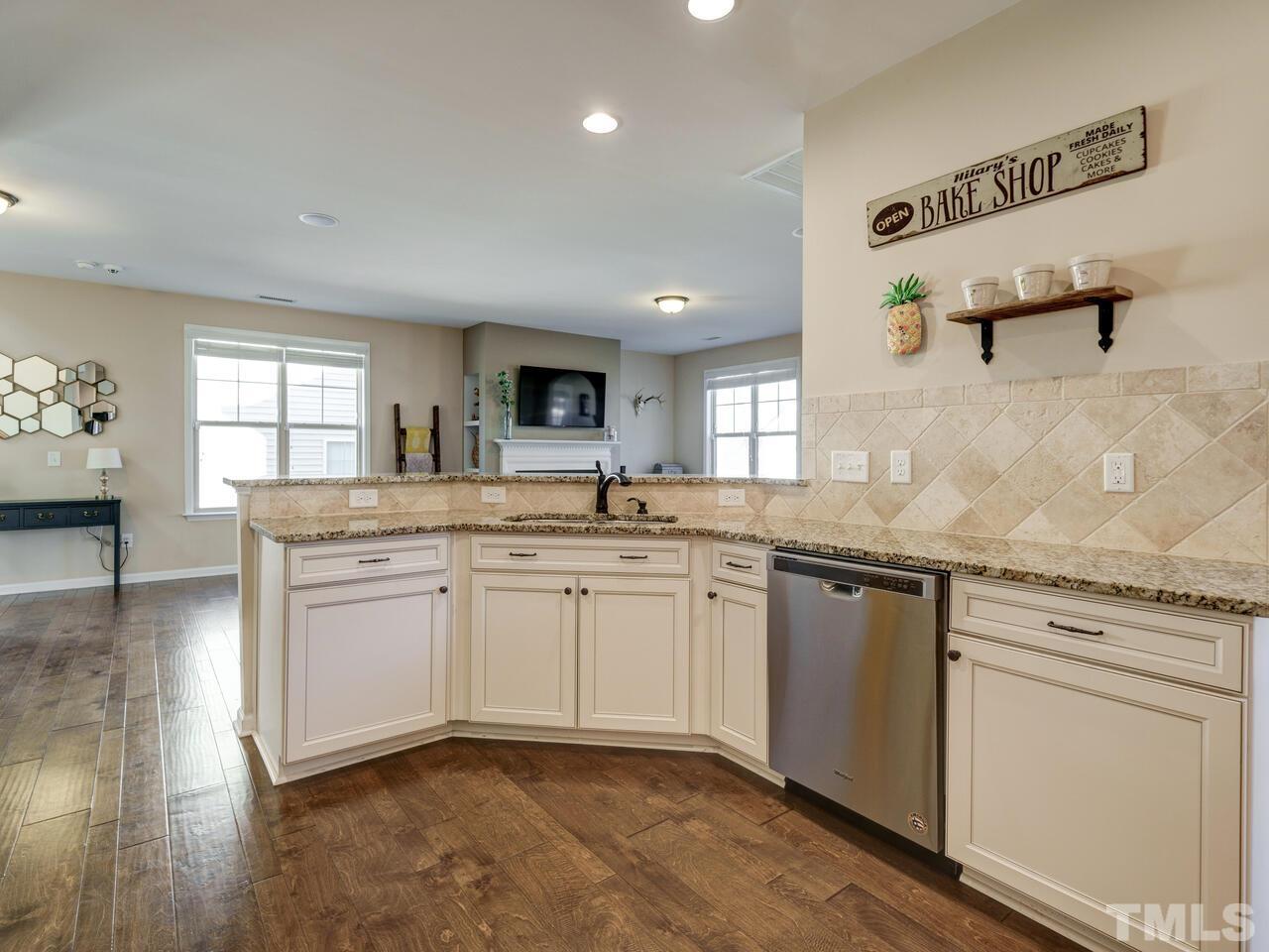 207 Maple Walk Street Durham, NC 27703 - Photo 27 of 50 a kitchen with granite countertop cabinets stainless steel appliances a sink and a window