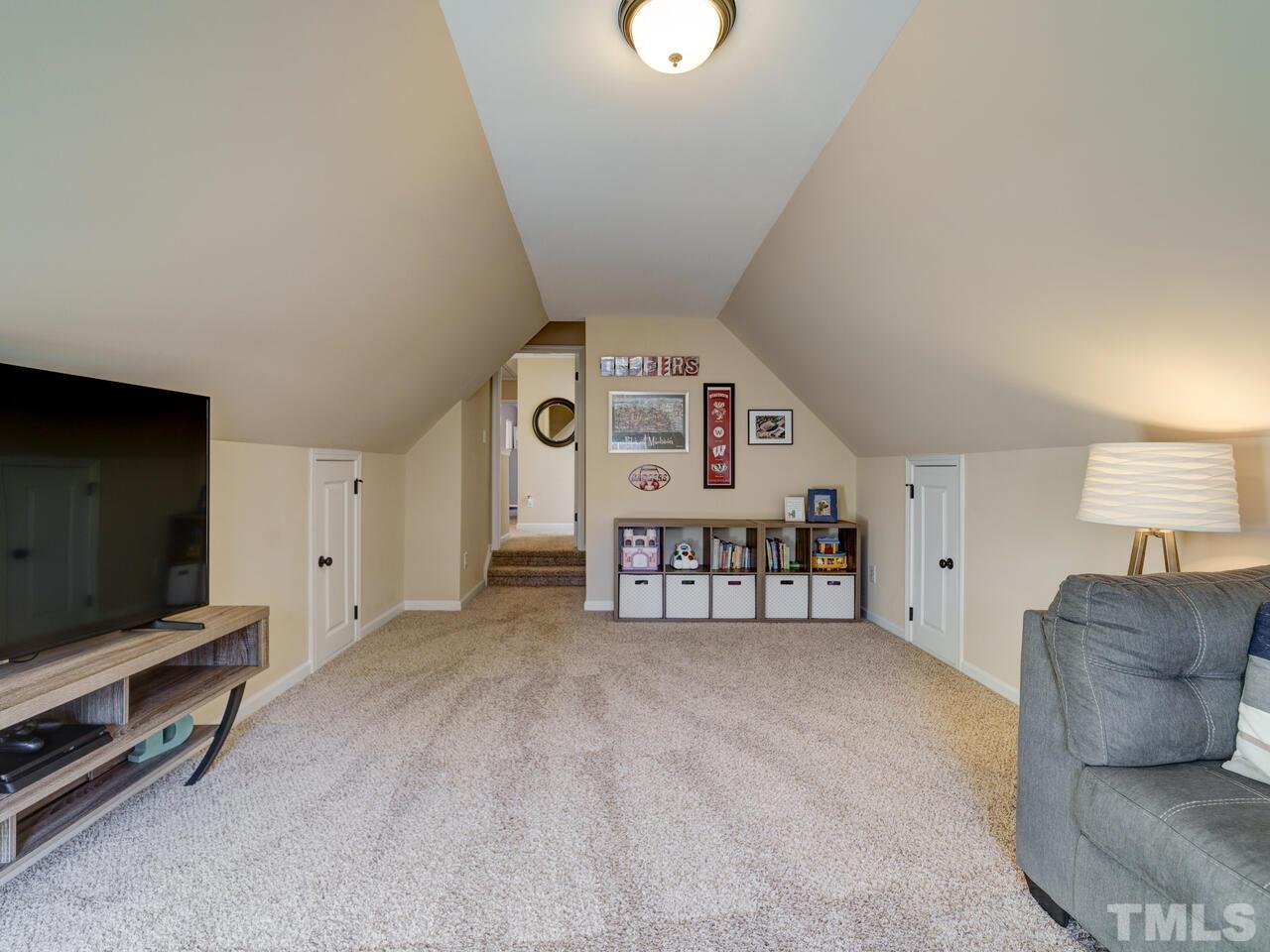 207 Maple Walk Street Durham, NC 27703 - Photo 30 of 50 a living room with furniture and a flat screen tv