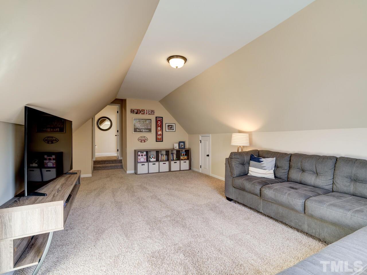 207 Maple Walk Street Durham, NC 27703 - Photo 31 of 50 a living room with furniture and a flat screen tv