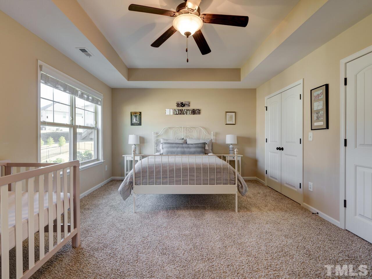 207 Maple Walk Street Durham, NC 27703 - Photo 33 of 50 a bedroom with a bed and window