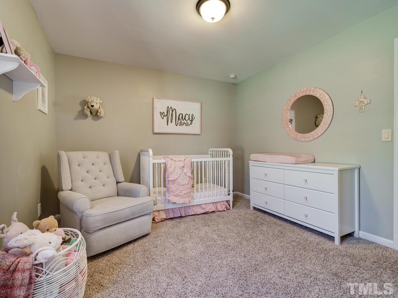 207 Maple Walk Street Durham, NC 27703 - Photo 37 of 50 a bedroom with a bed and a dresser