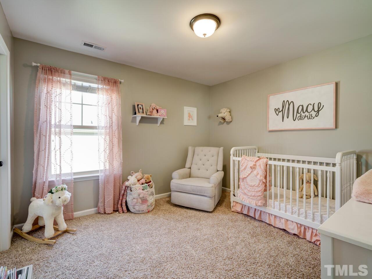 207 Maple Walk Street Durham, NC 27703 - Photo 38 of 50 a bedroom with furniture and a window