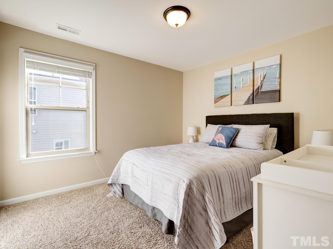 207 Maple Walk Street Durham, NC 27703 - Photo 41 of 50 a bedroom with a bed and a window