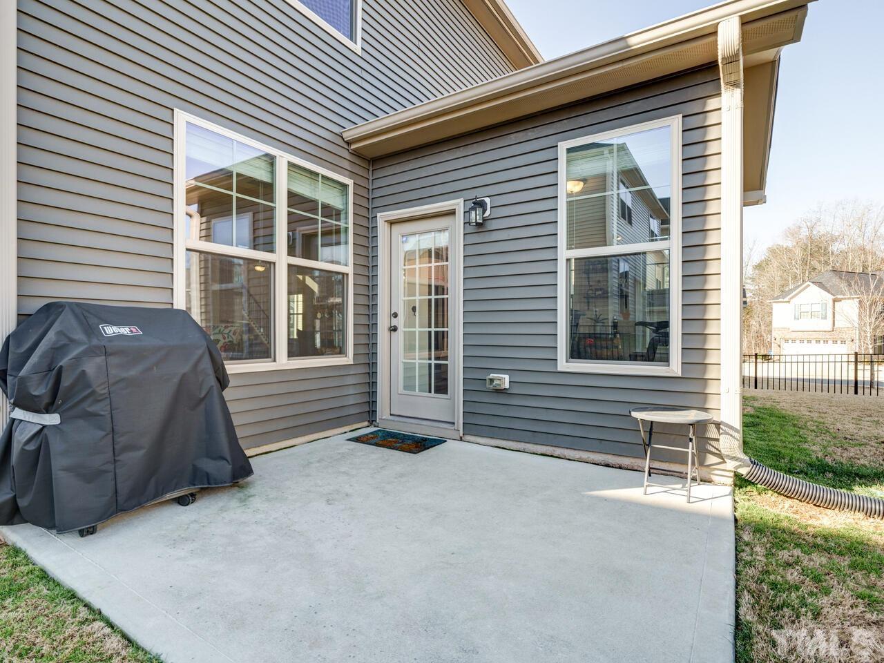207 Maple Walk Street Durham, NC 27703 - Photo 46 of 50 a front view of a house with a yard