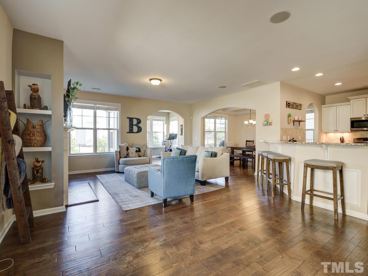 207 Maple Walk Street Durham, NC 27703 - Photo 5 of 50 a living room with furniture and a dining table with wooden floor