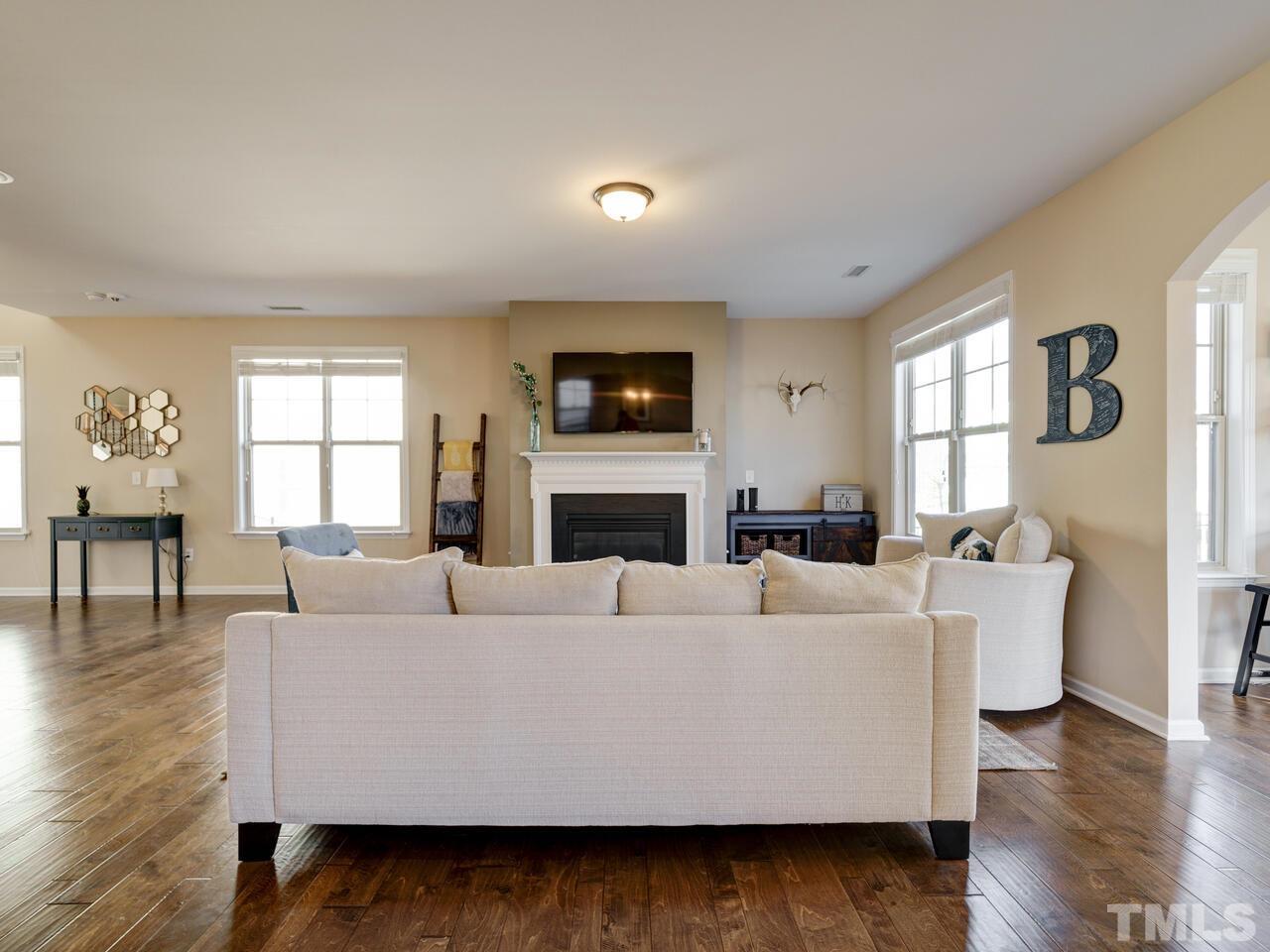 207 Maple Walk Street Durham, NC 27703 - Photo 6 of 50 a living room with fireplace furniture and a flat screen tv