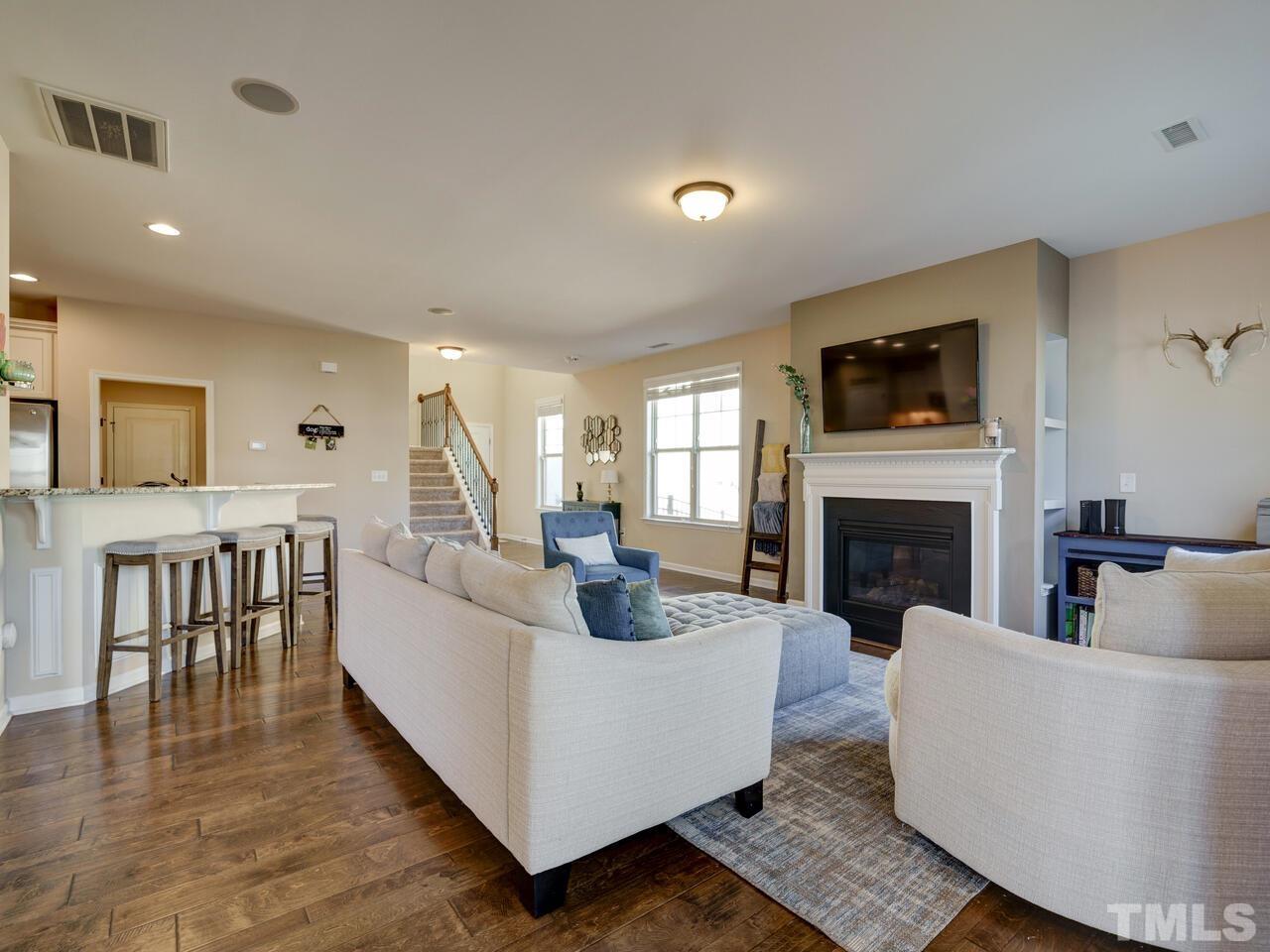 207 Maple Walk Street Durham, NC 27703 - Photo 7 of 50 a living room with furniture a flat screen tv and a fireplace