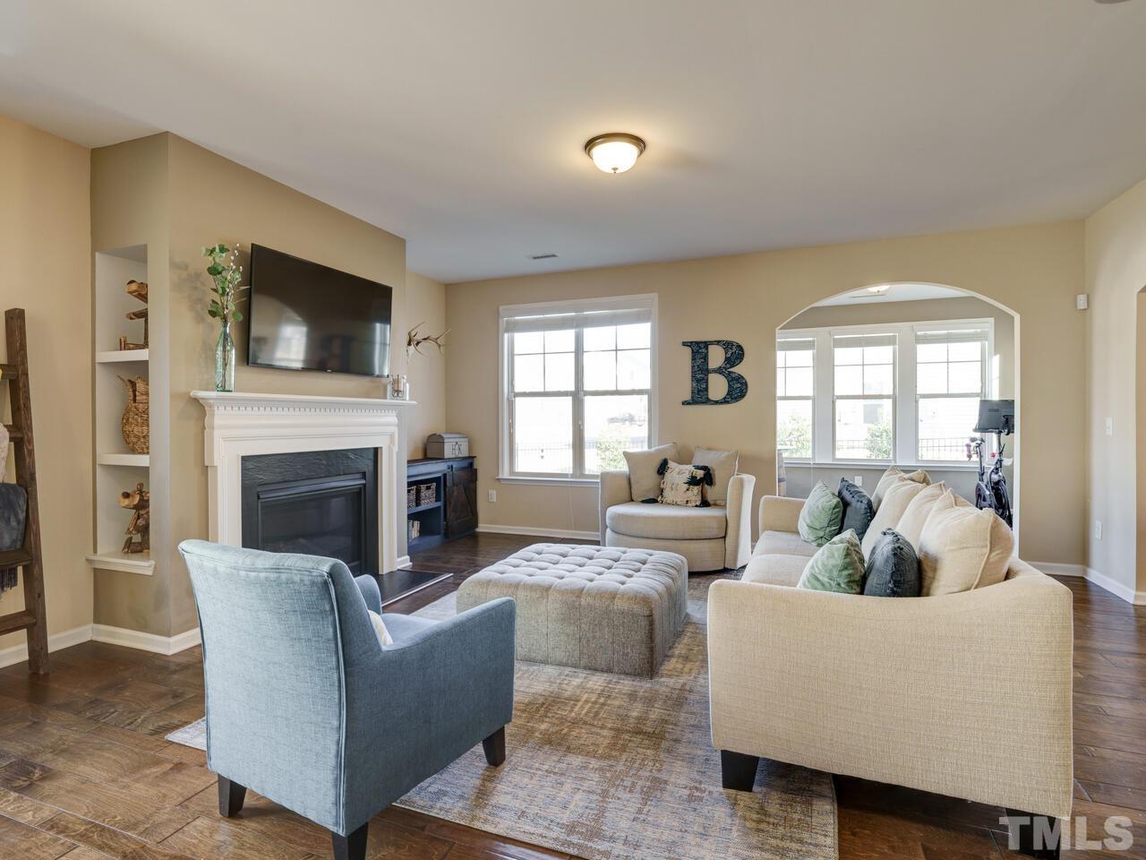 207 Maple Walk Street Durham, NC 27703 - Photo 8 of 50 a living room with furniture a flat screen tv and a fireplace