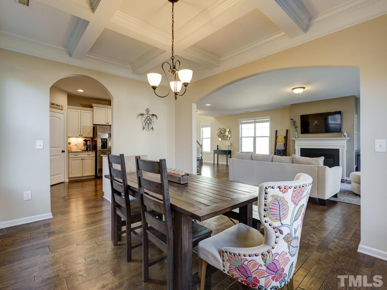 207 Maple Walk Street Durham, NC 27703 - Photo 9 of 50 a view of a dining room with furniture a chandelier and wooden floor