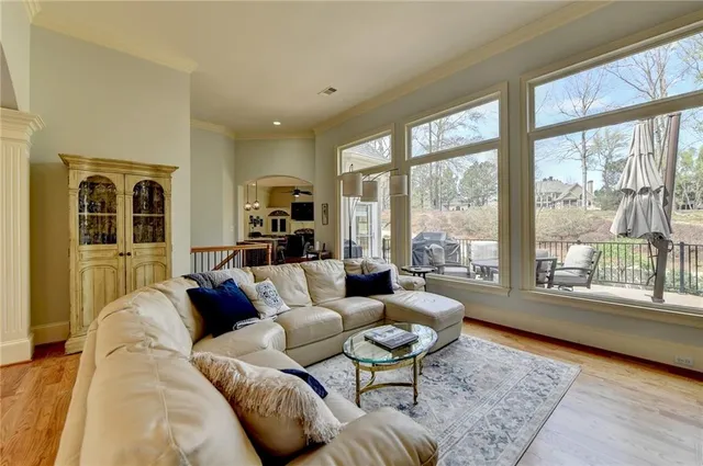 a spacious bedroom with a bed a couch and a chandelier