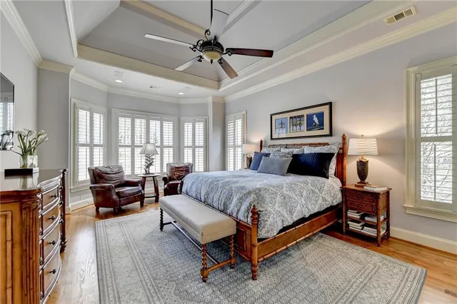 a bathroom with a granite countertop double vanity sink mirror bathtub and shower