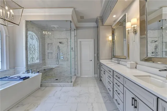 a bathroom with double vanity sinks and a mirror