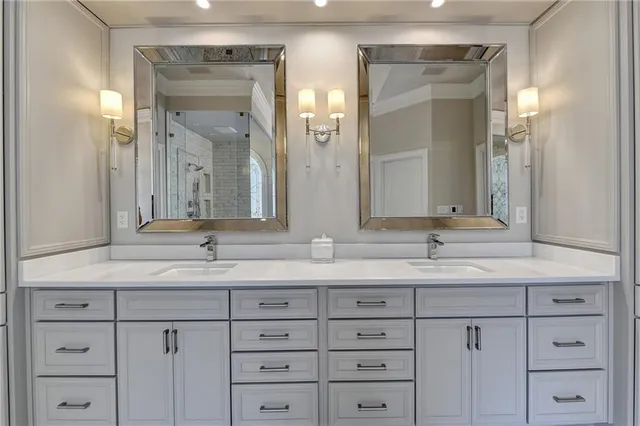 a spacious bathroom with a double vanity sink tub and mirror
