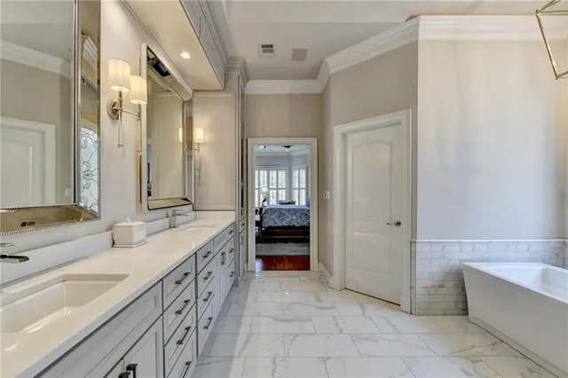 a spacious bathroom with a double vanity sink and a large mirror