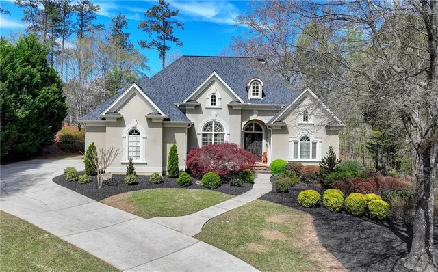a front view of a house with a garden