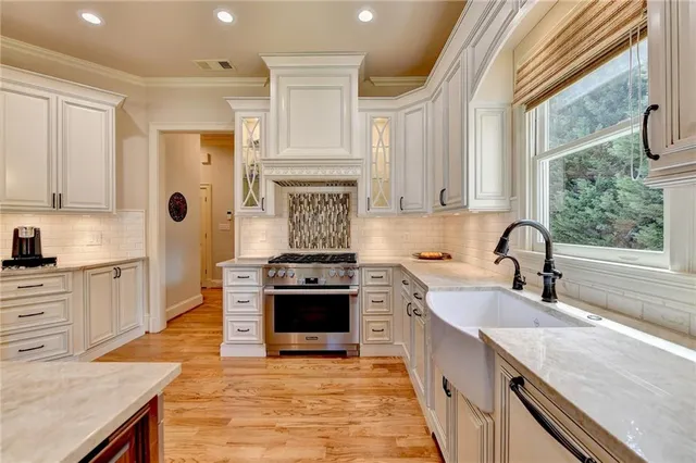a kitchen with stainless steel appliances granite countertop a stove and a sink with granite countertops