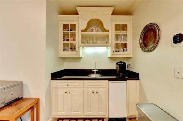 a bedroom with double bed windows and a chandelier