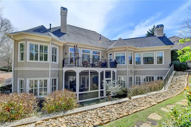 a view of a patio with couches chairs and wooden floor