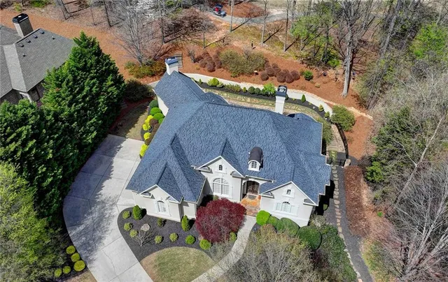 an aerial view of house with yard and outdoor seating