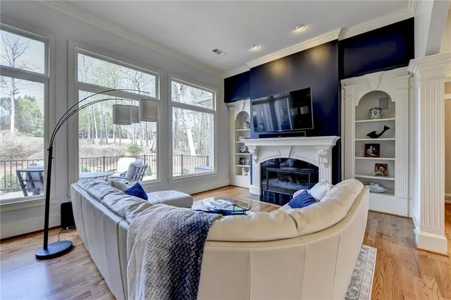 a living room with furniture a flat screen tv and a fireplace